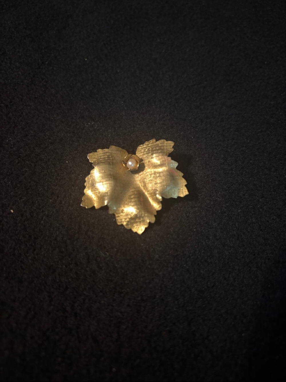vintage golden leaf brooch featuring a textured design and a central faux pearl